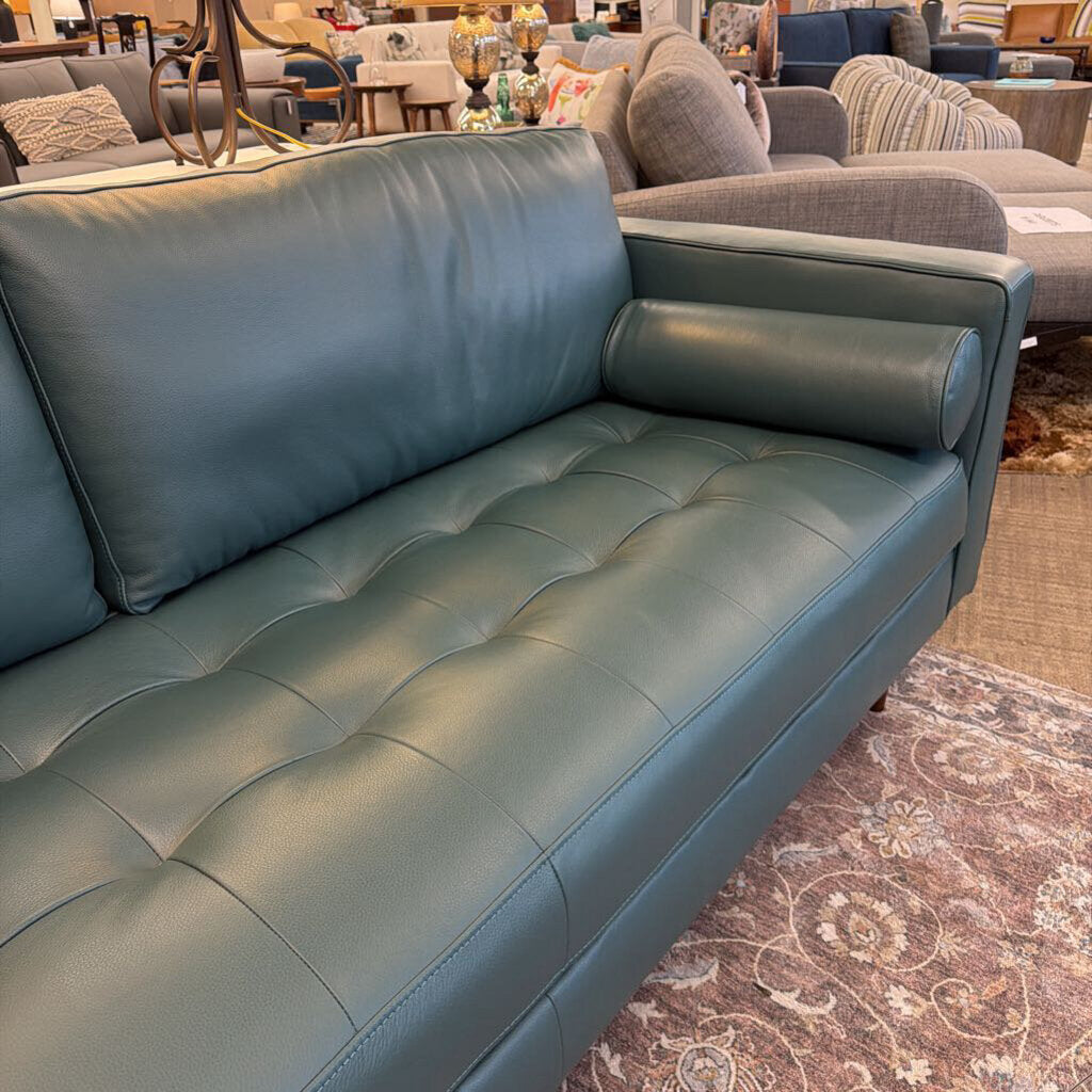 Blue leather sofa in a furniture store setting