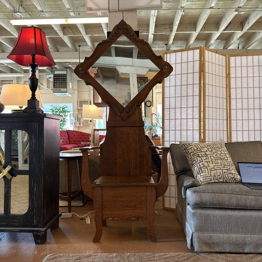 Wooden mirror with red lampshade in a room with furniture and decor