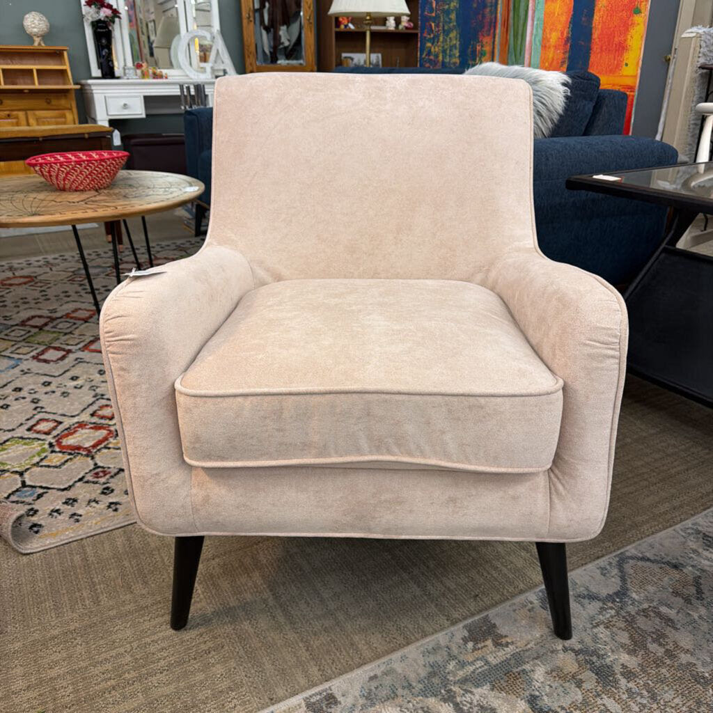 Beige armchair in a room with colorful decor