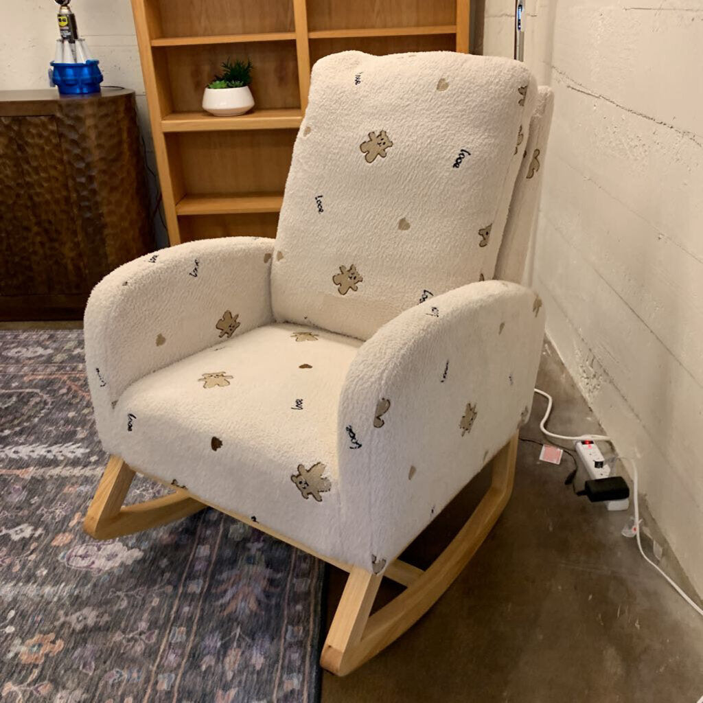 Rocking chair with patterned cushion on a carpeted floor next to a bookshelf.