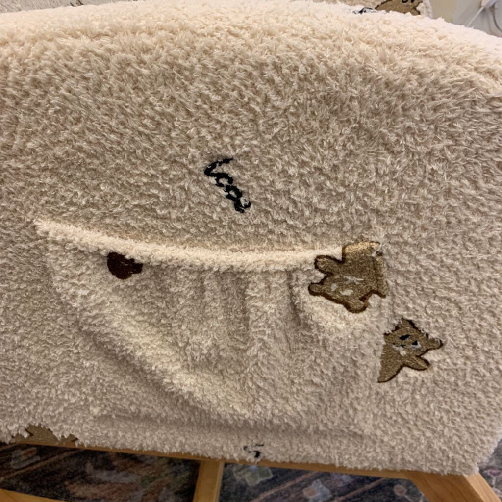 Beige textured surface with decorative elements on a wooden stand