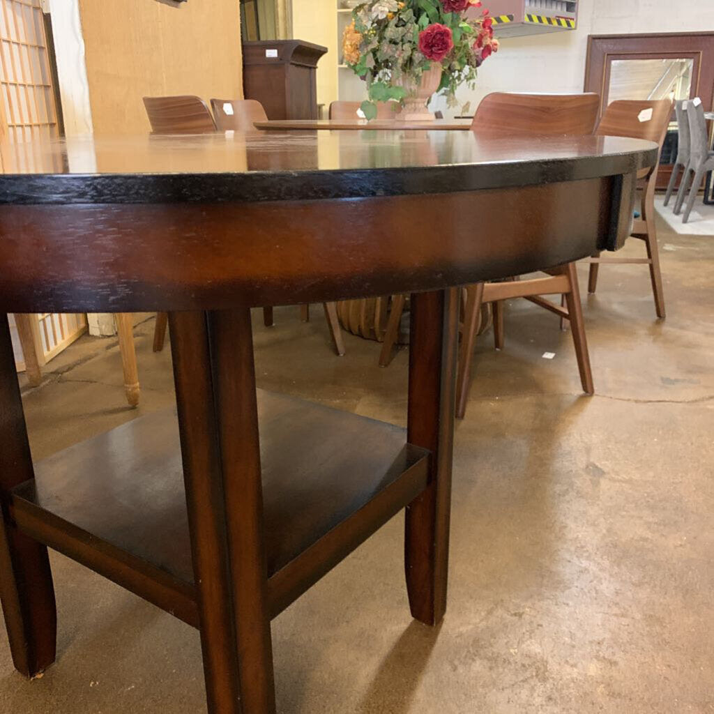 Wooden dining table with chairs in a showroom setting