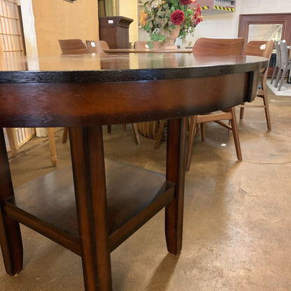 Wooden dining table with chairs in a showroom setting