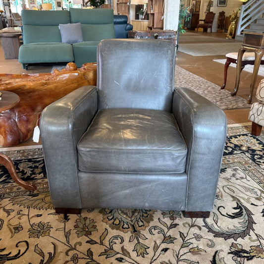 Gray leather armchair in a room with furniture and decor