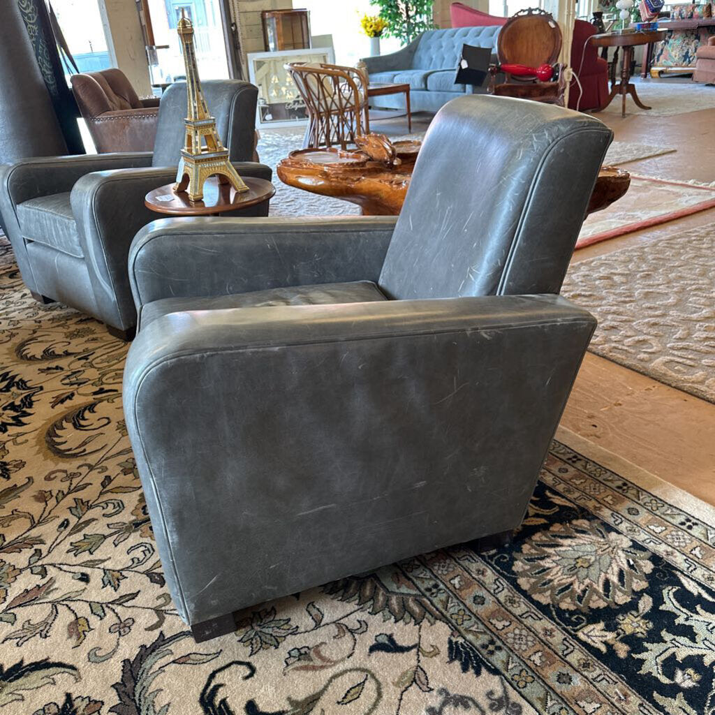 Gray armchair in a room with patterned rug and furniture