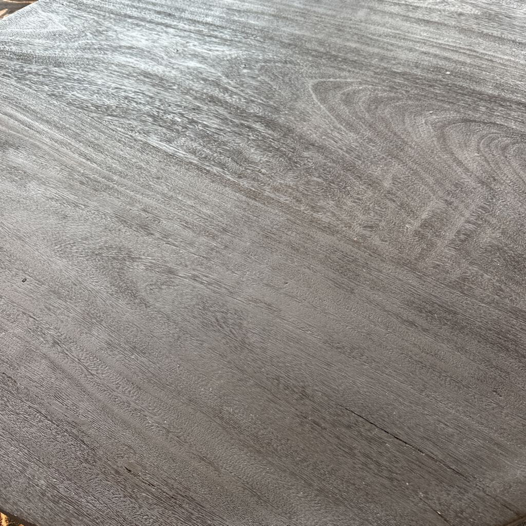 Close-up of a gray wooden surface with visible grain.