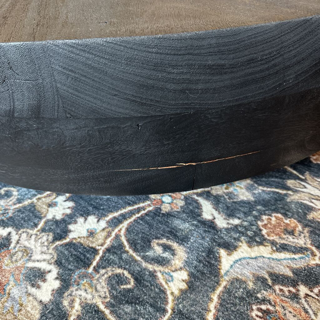Close-up of a black tire on a patterned rug