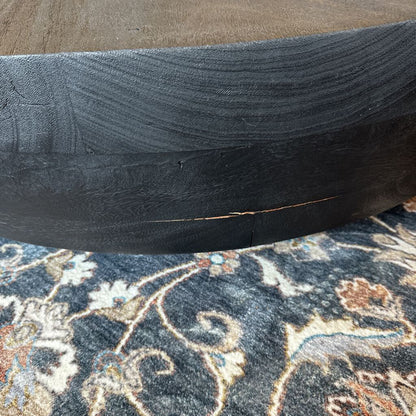Close-up of a black tire on a patterned rug