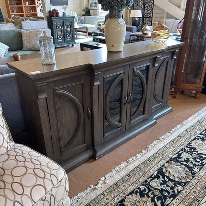 Wooden sideboard in a living room setting with decor items on top