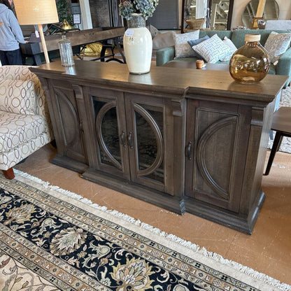 Wooden console table with decorative items in a living room setting