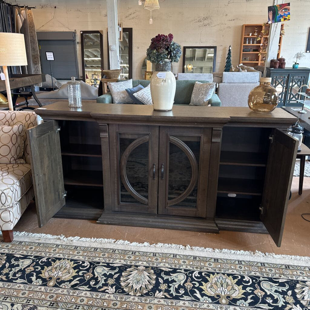Dark wooden sideboard with open doors in a living room setting