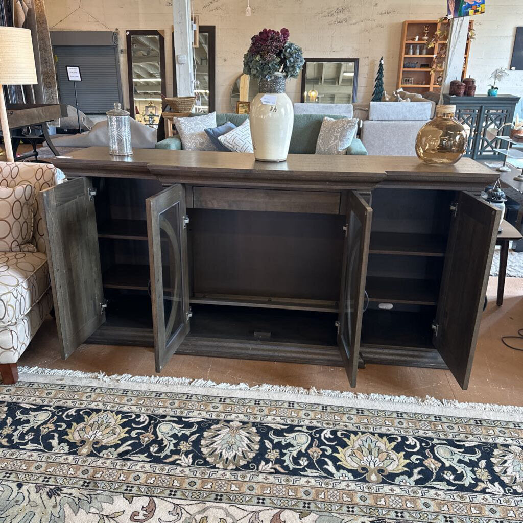 Wooden sideboard with open doors in a living room setting