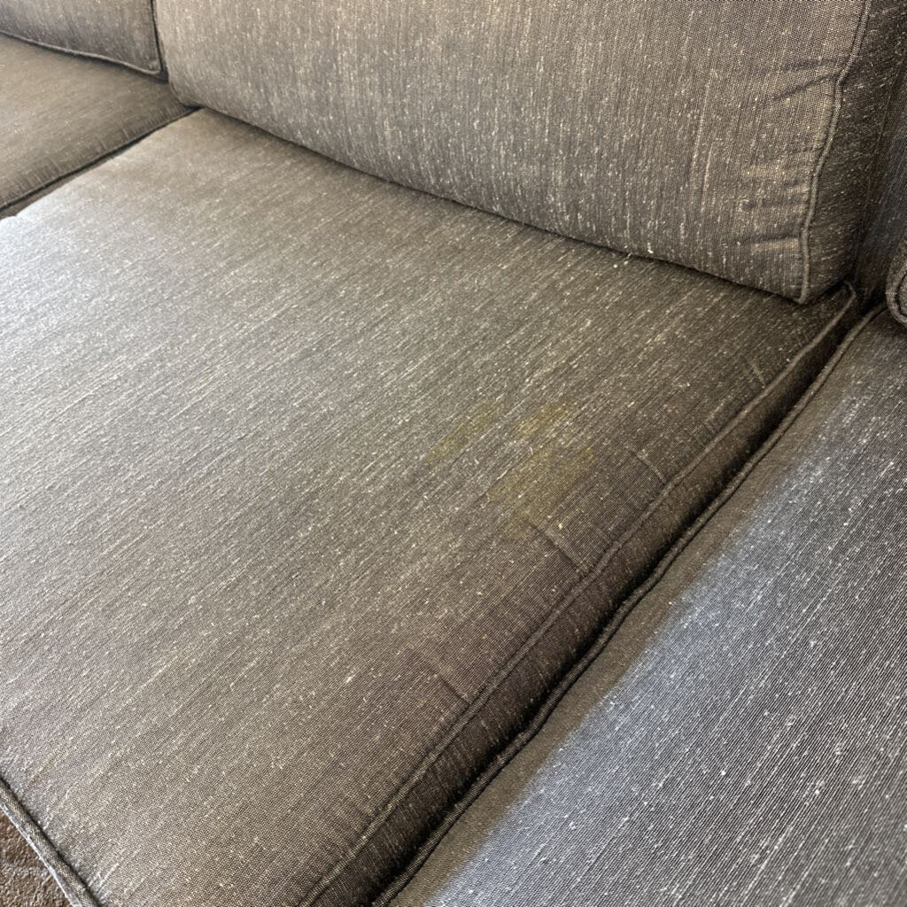 Brown textured sofa with visible wear and tear