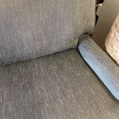 Gray upholstered chair with a visible seam