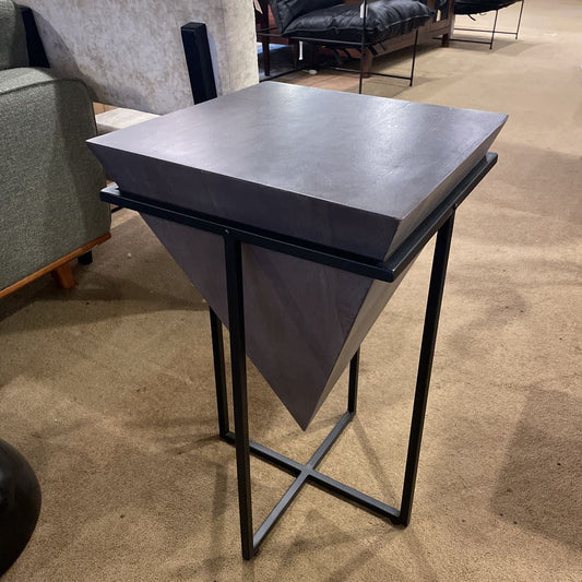 Black side table in a room with furniture