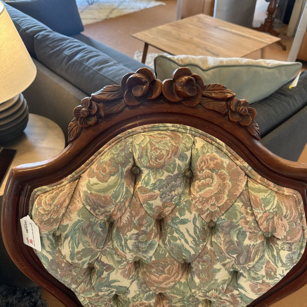 Decorative chair with floral pattern and wooden frame in a room setting