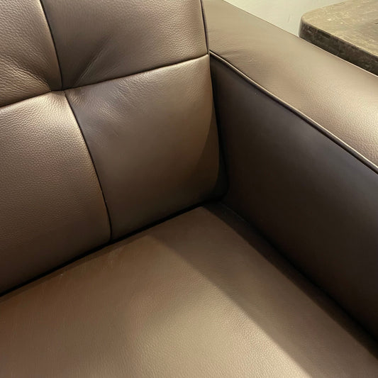Brown leather corner sofa with a textured surface.