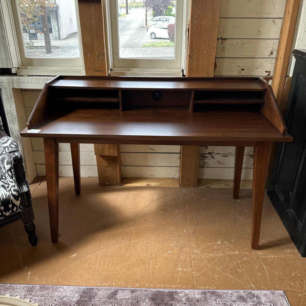 Wooden desk in a room with wooden floor and window