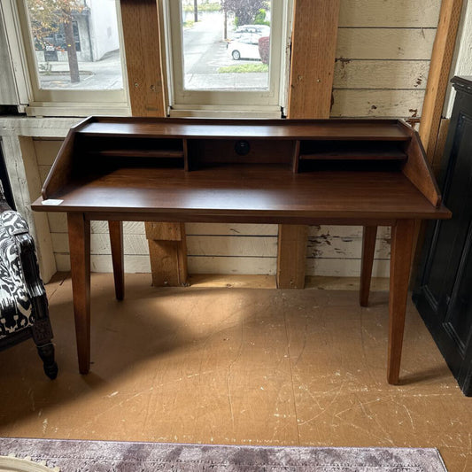 Wooden desk in a room with wooden floor and window