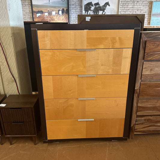Wooden dresser with multiple drawers in a store setting