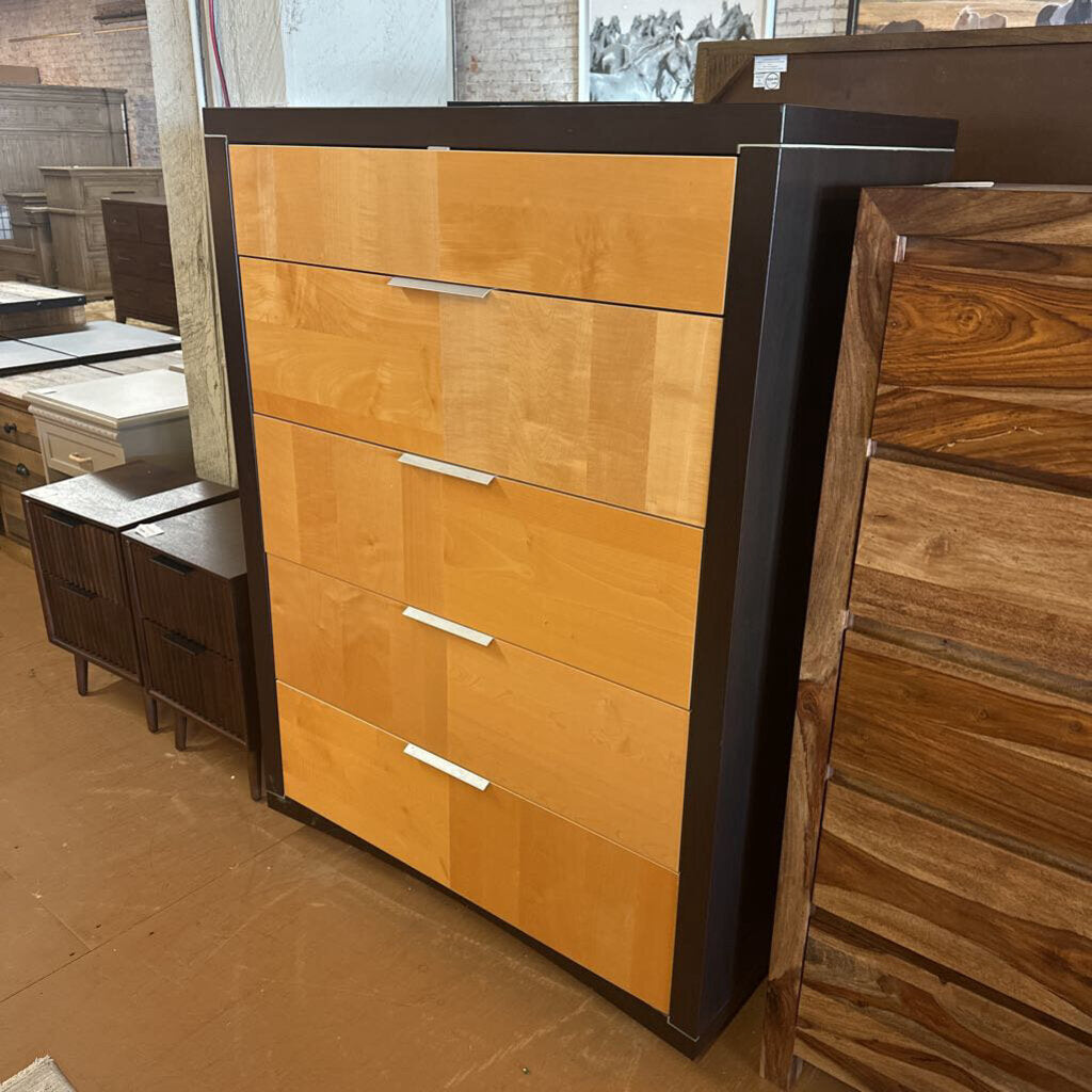 Wooden dresser with multiple drawers in a showroom setting