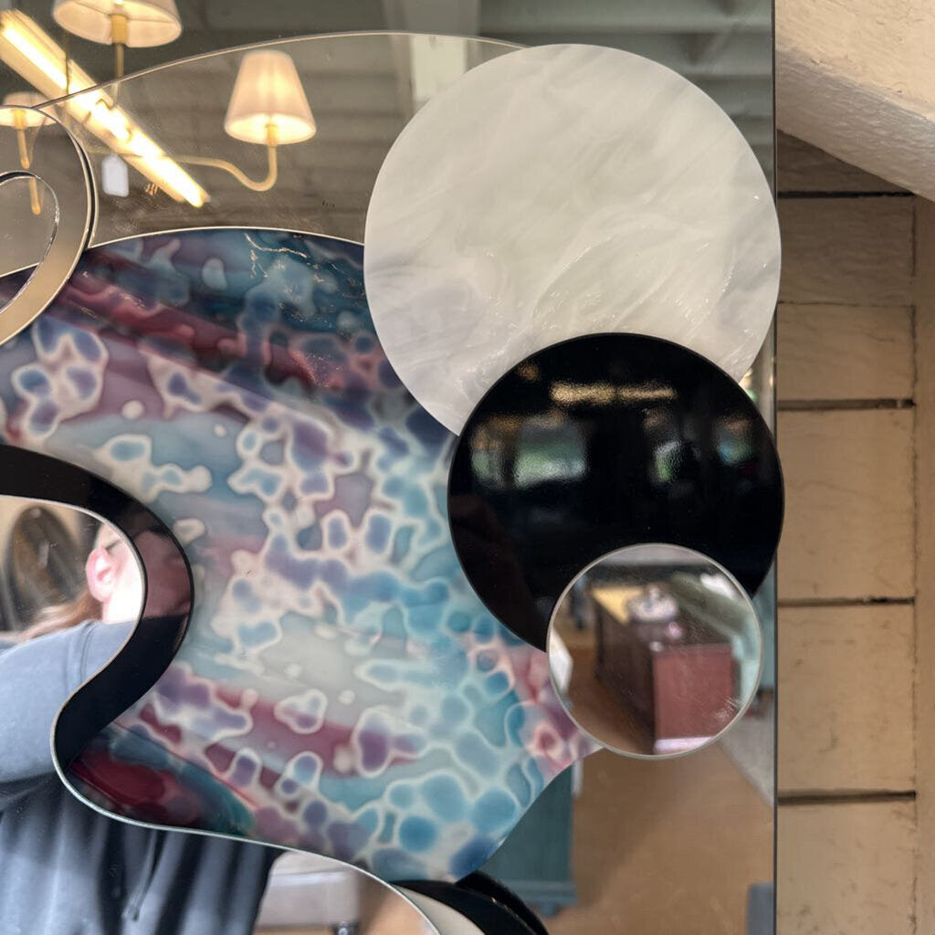 Decorative mirror with abstract design and reflective surface