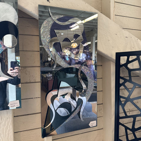 Decorative mirror with abstract design on a wall