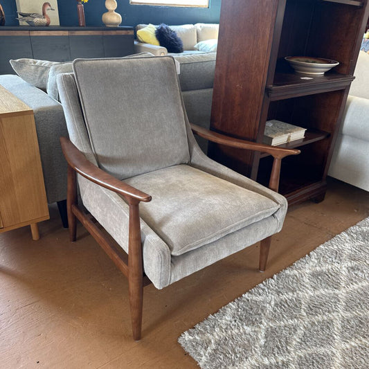 Gray armchair with wooden arms in a living room setting