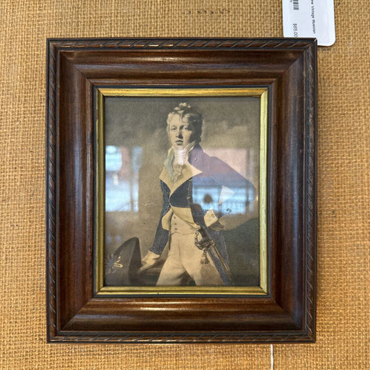 Framed portrait of a man in formal attire on a textured beige background