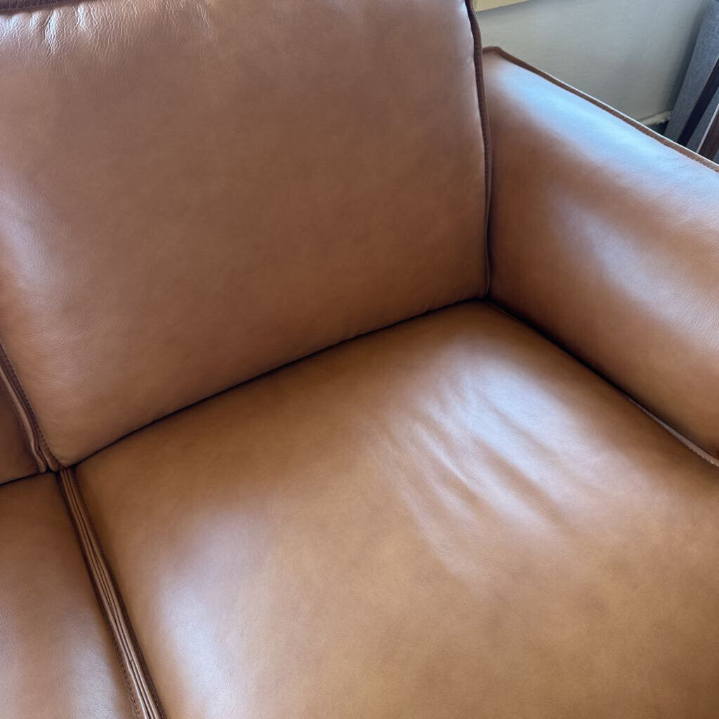 Brown leather sofa with a shiny surface