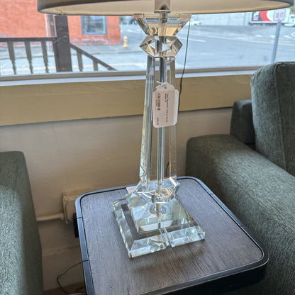 Crystal table lamp on a side table with a blurred background