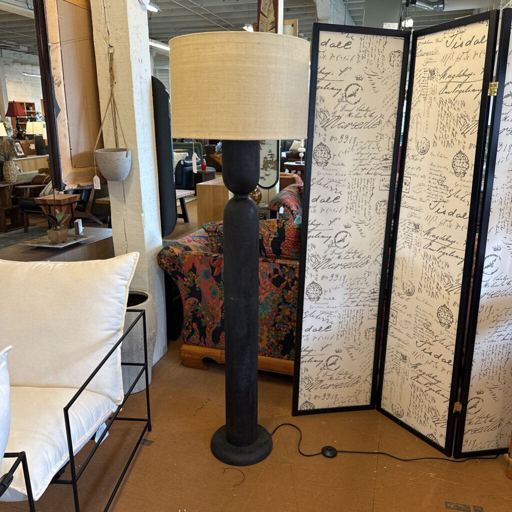 Floor lamp with a decorative screen in a store setting