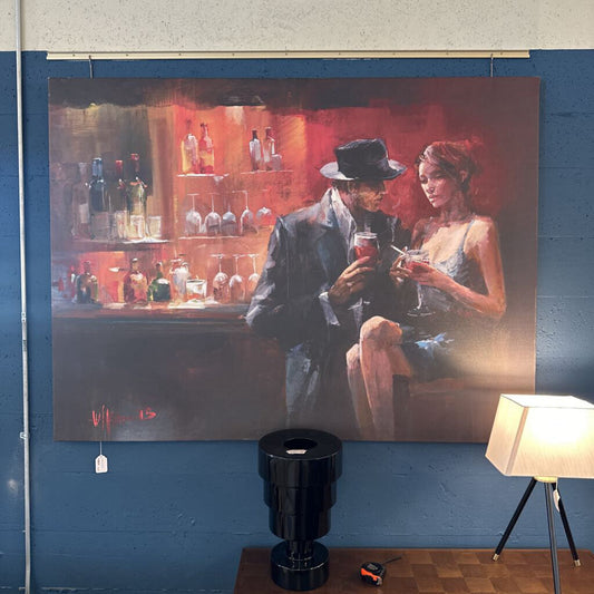 Painting of a couple in a bar setting on a blue wall with a lamp and trash can below.