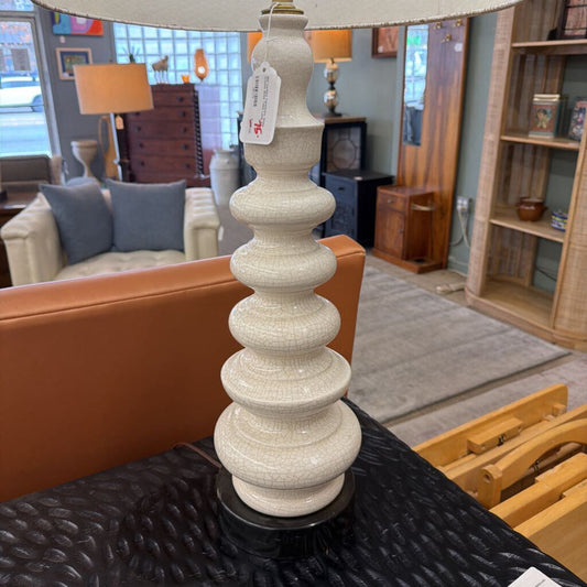 Decorative lamp with a tag on a table in a furniture store setting