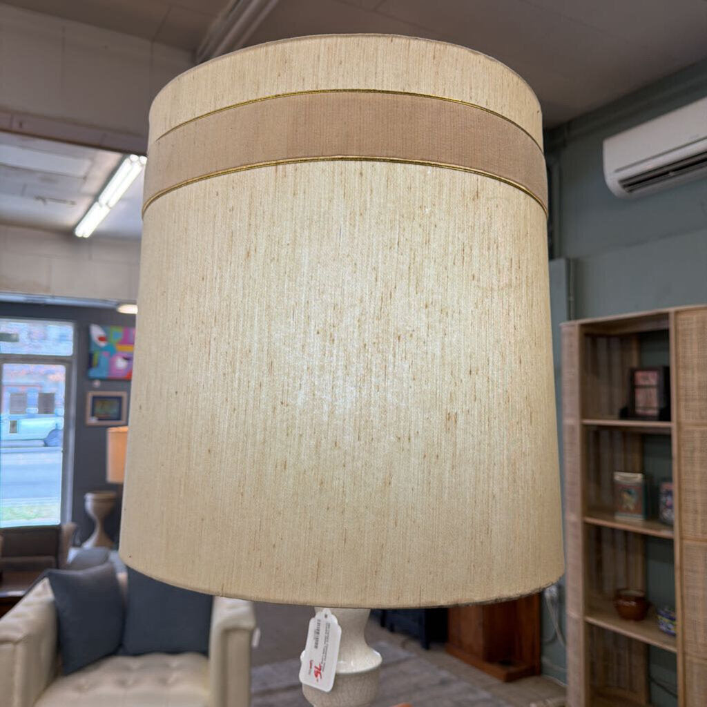 Beige lampshade with a tag in an indoor setting