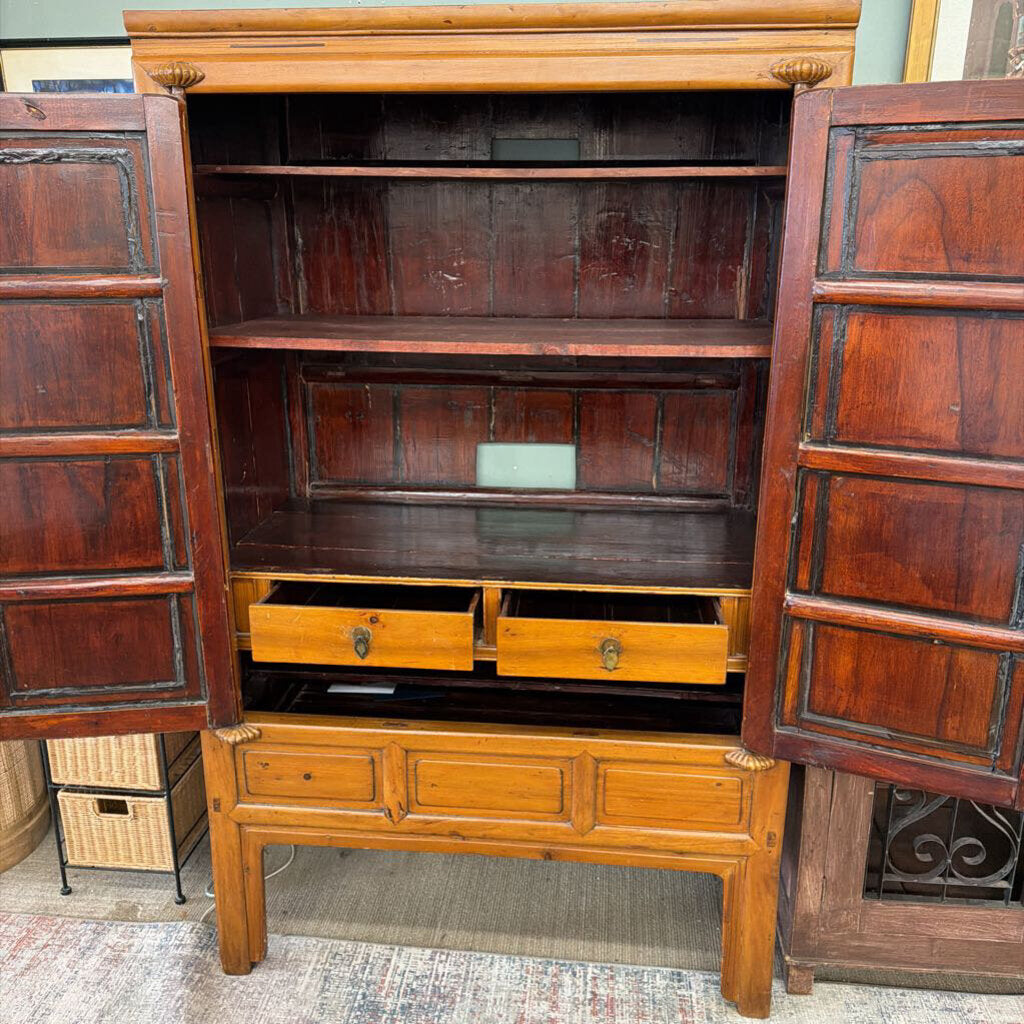 Wooden cabinet with open doors revealing shelves and drawers.