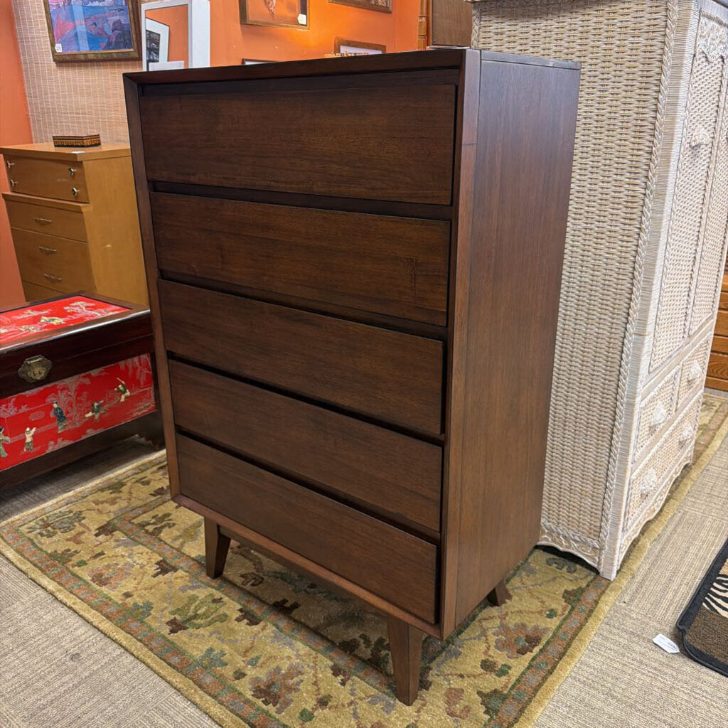 Wooden dresser with four drawers in a room setting
