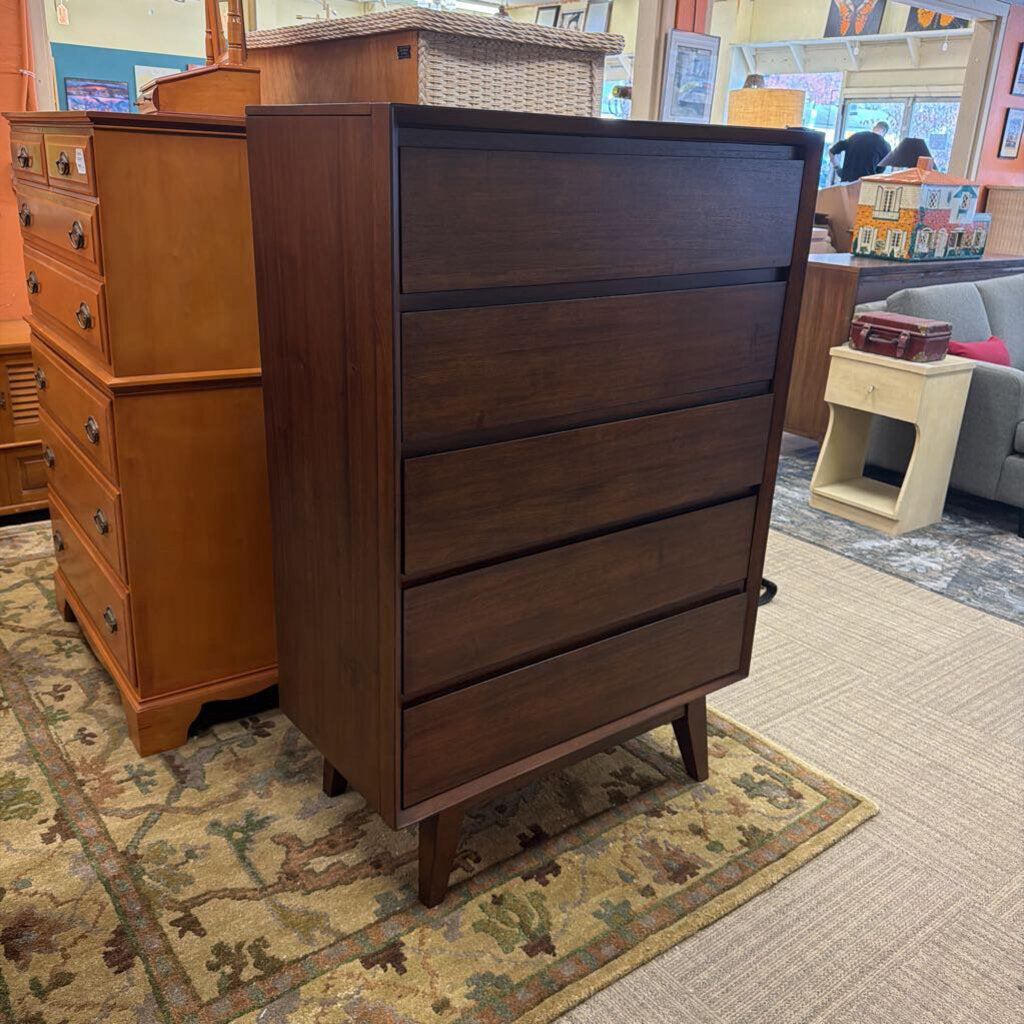Wooden dresser with multiple drawers in a store setting