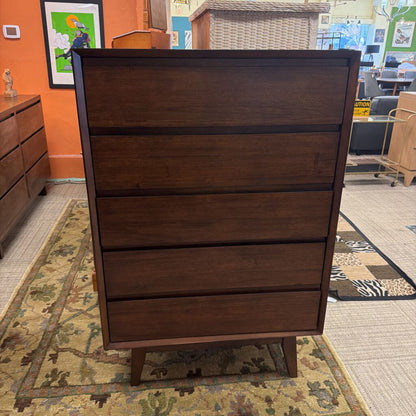 Wooden dresser with four drawers in a store setting