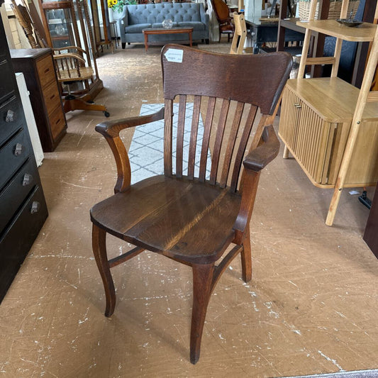 Wooden chair in a furniture store with various items in the background