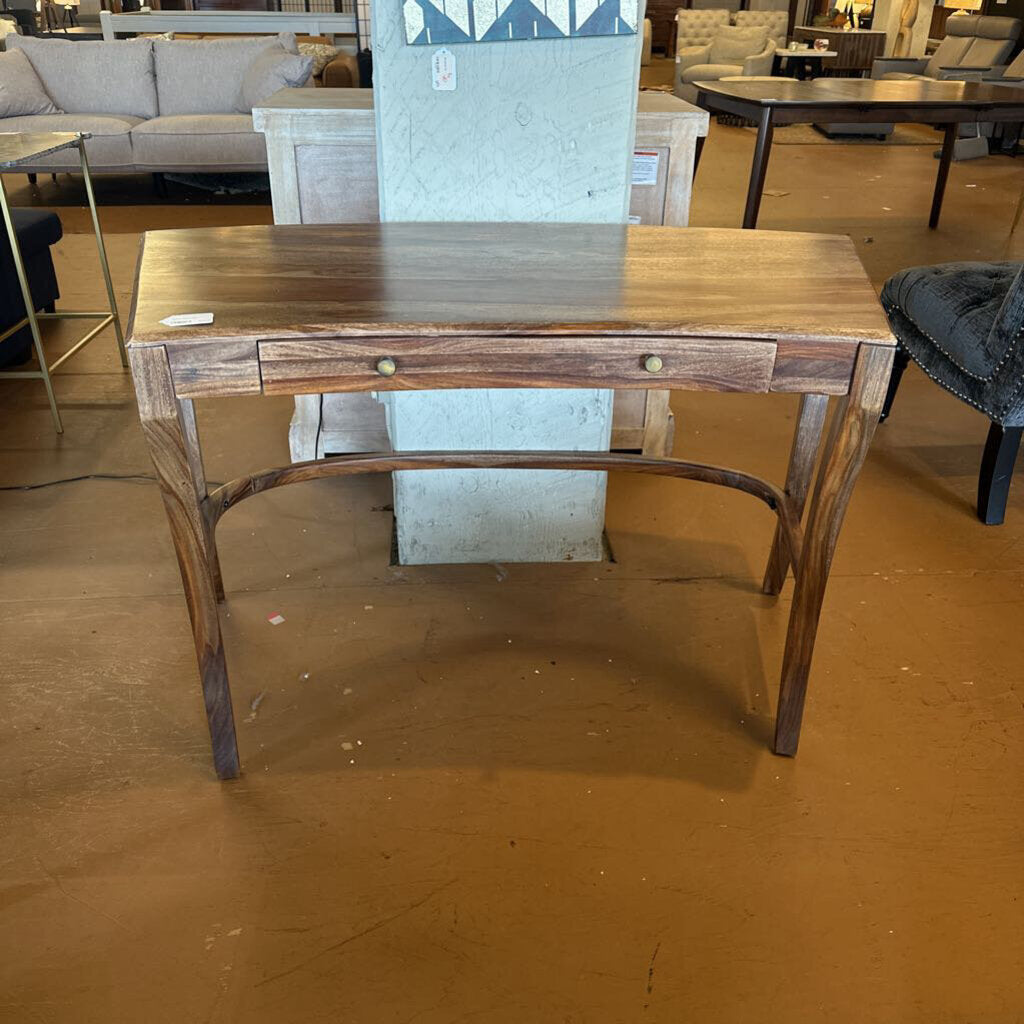 Wooden desk with a single drawer in a room setting