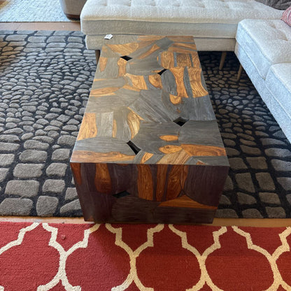 Wooden coffee table with a unique design in a living room setting