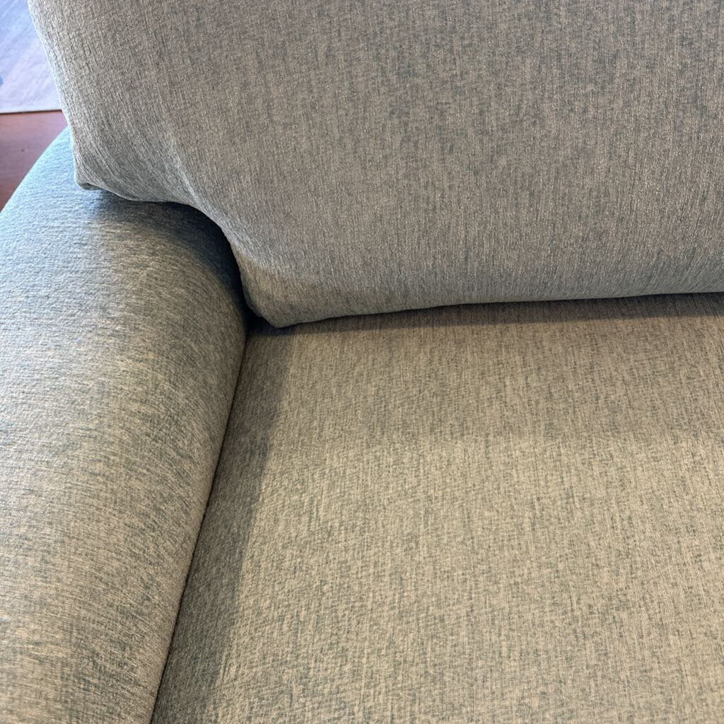 Close-up of a textured gray sofa corner