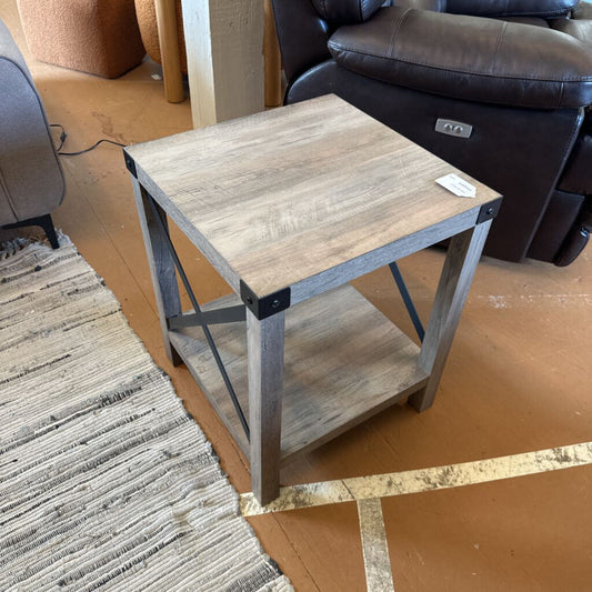 Wooden side table with metal legs in a living room setting