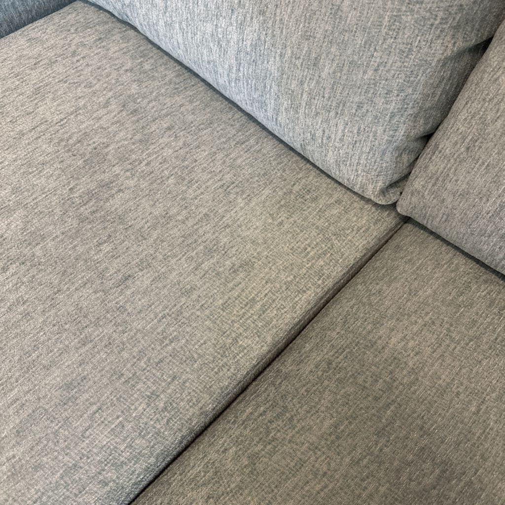 Gray fabric texture on a sofa corner