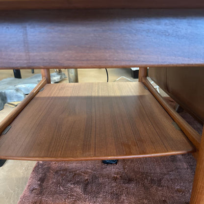 Wooden shelf with a smaller wooden surface on top, on a carpeted floor.