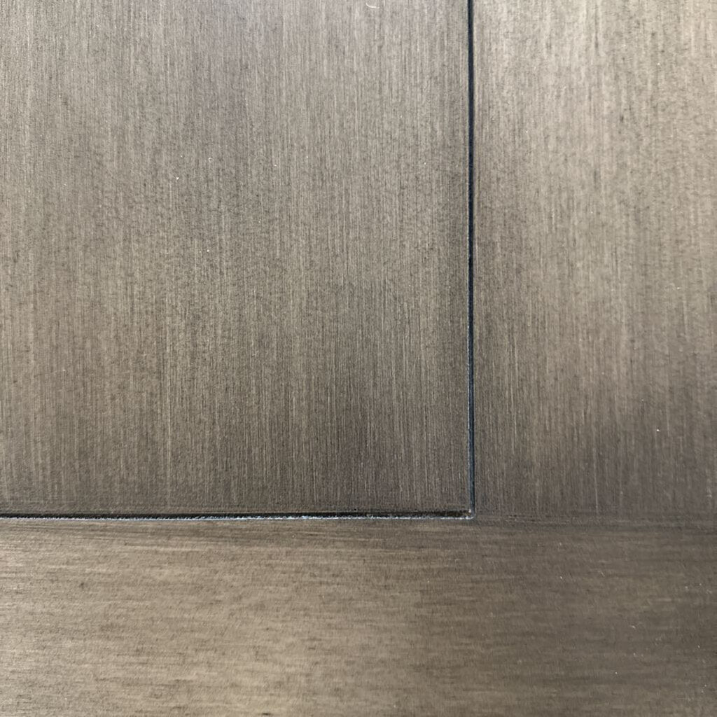 Close-up of a wooden panel with a visible grain pattern