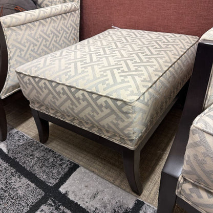 Patterned ottoman and chairs on a gray and black checkered rug
