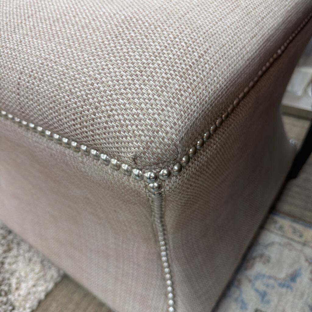 Close-up of a textured fabric surface with metallic trim