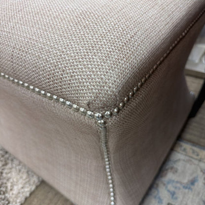 Close-up of a textured fabric surface with metallic trim